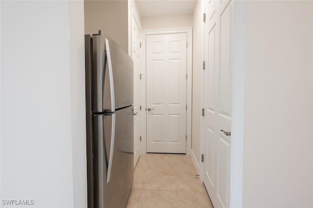 hall featuring light tile patterned floors