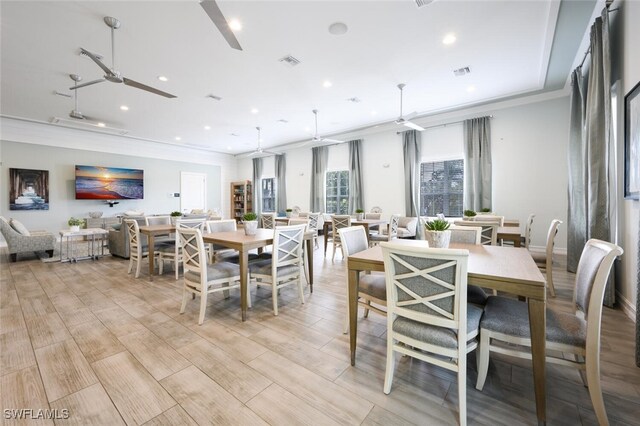 dining area with light wood-type flooring, ceiling fan, and crown molding