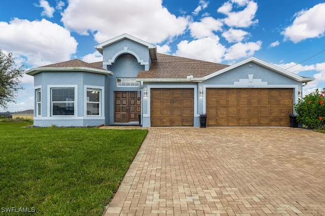 view of front of home with a garage and a front yard