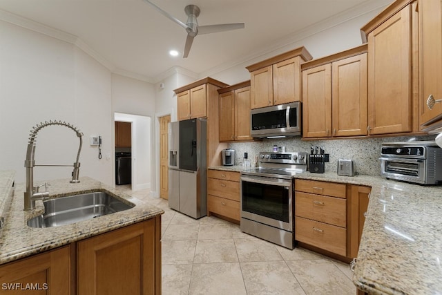 kitchen with appliances with stainless steel finishes, light stone counters, crown molding, ceiling fan, and sink