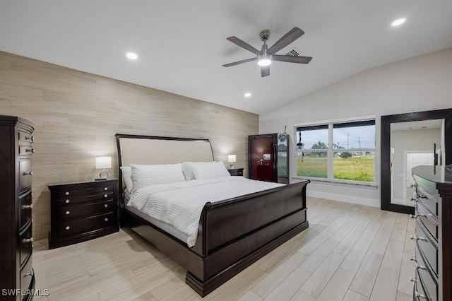 bedroom with lofted ceiling, ceiling fan, and light hardwood / wood-style flooring