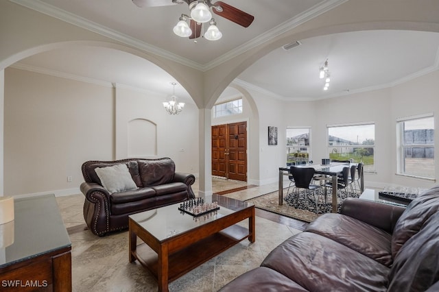 living room with ceiling fan with notable chandelier and crown molding