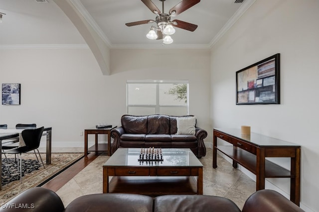 living room featuring ceiling fan, light wood-type flooring, and ornamental molding