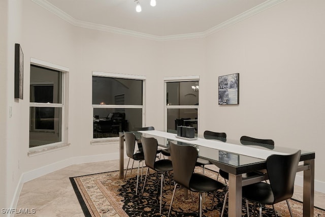 tiled dining area featuring crown molding