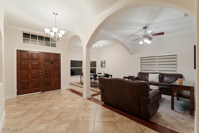 foyer featuring ceiling fan with notable chandelier and ornamental molding