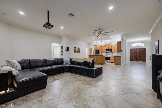 living room featuring ornamental molding and ceiling fan