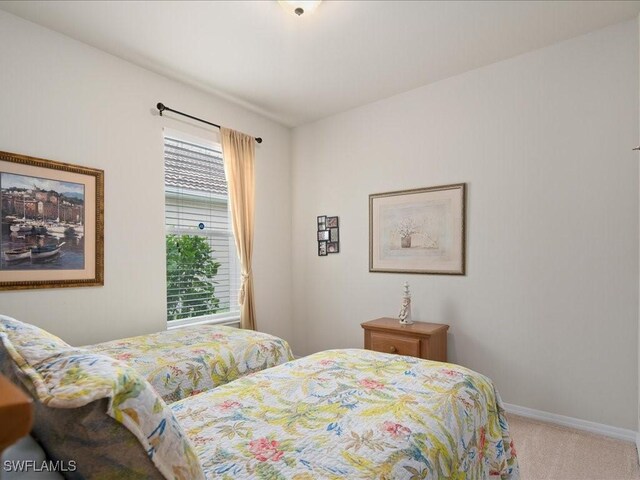 carpeted bedroom featuring baseboards