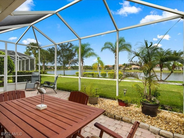 view of patio with a water view, glass enclosure, and outdoor dining space