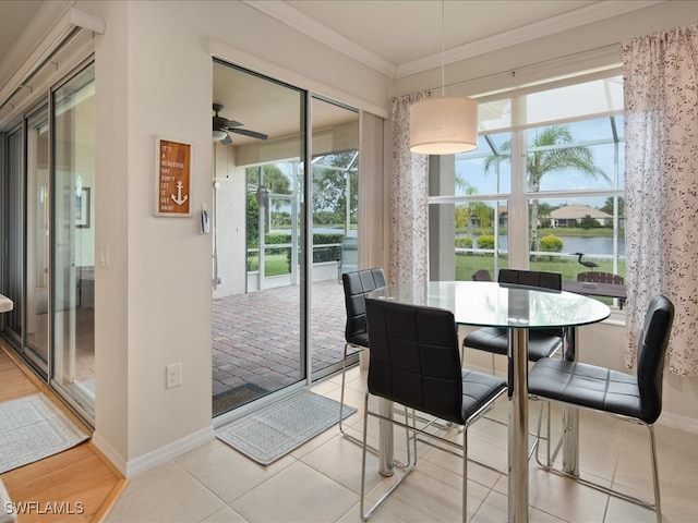 dining space with ceiling fan, ornamental molding, tile patterned floors, and baseboards