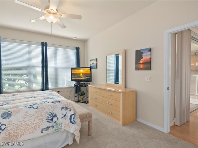 bedroom featuring baseboards, a ceiling fan, and light colored carpet