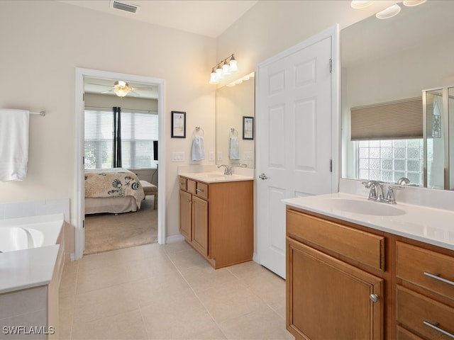 full bath featuring tile patterned flooring, plenty of natural light, visible vents, and a sink