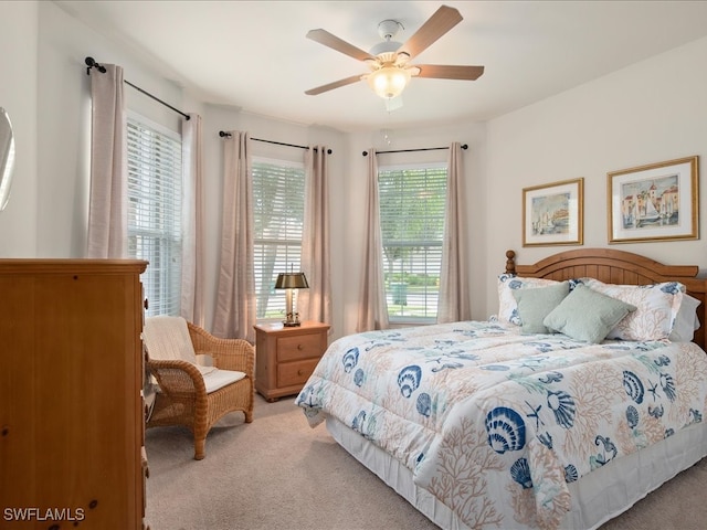 bedroom featuring ceiling fan and carpet