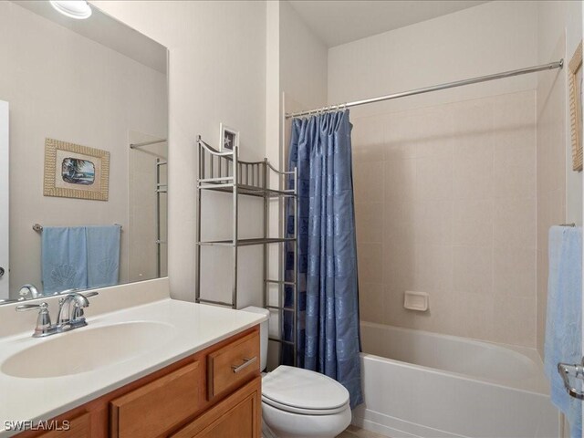 bathroom with vanity, toilet, and shower / bathtub combination with curtain