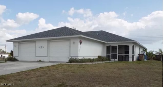 back of property featuring a garage and a sunroom