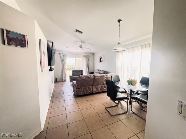 tiled dining area featuring ceiling fan