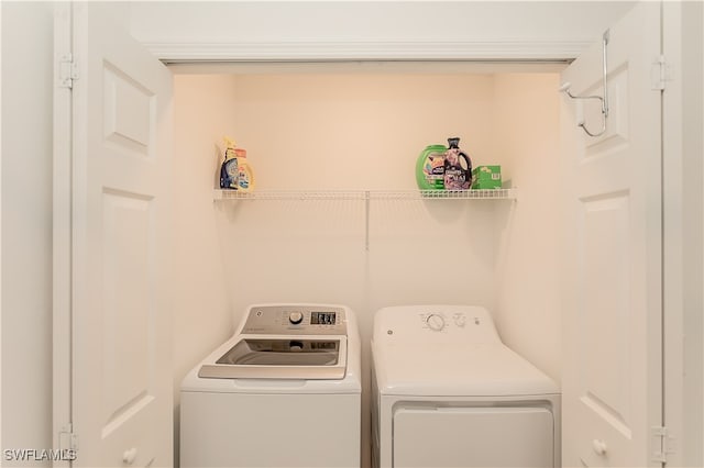 clothes washing area featuring washer and clothes dryer