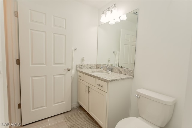 bathroom with wood-type flooring, vanity, and toilet