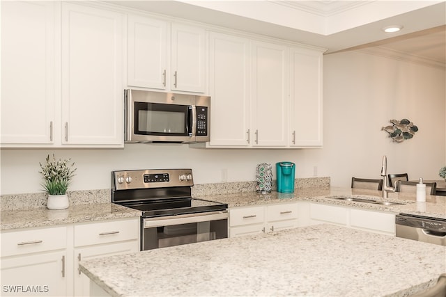 kitchen with appliances with stainless steel finishes, sink, and white cabinets