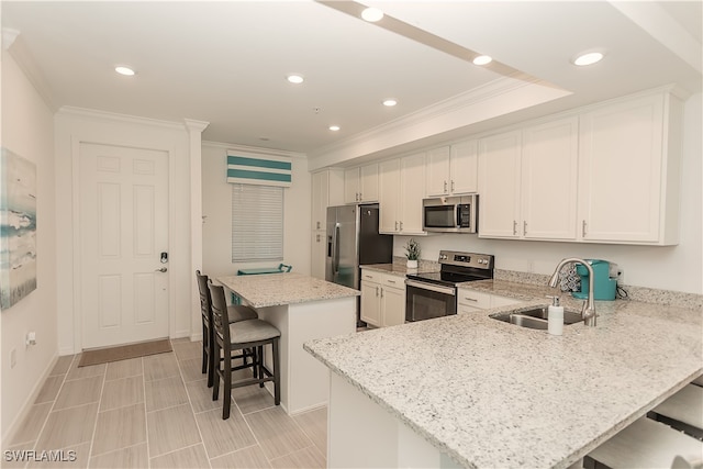 kitchen with light stone counters, sink, stainless steel appliances, a center island, and a kitchen bar