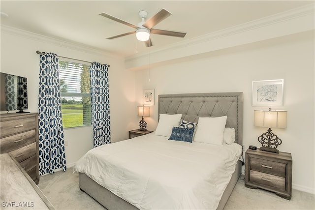 carpeted bedroom with ceiling fan and crown molding