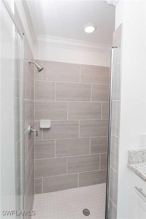 bathroom with vanity, ornamental molding, and an enclosed shower