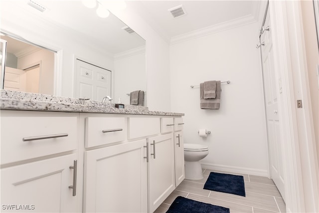 bathroom with crown molding, vanity, and toilet