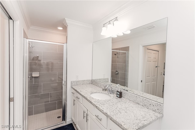 bathroom featuring vanity, crown molding, and an enclosed shower