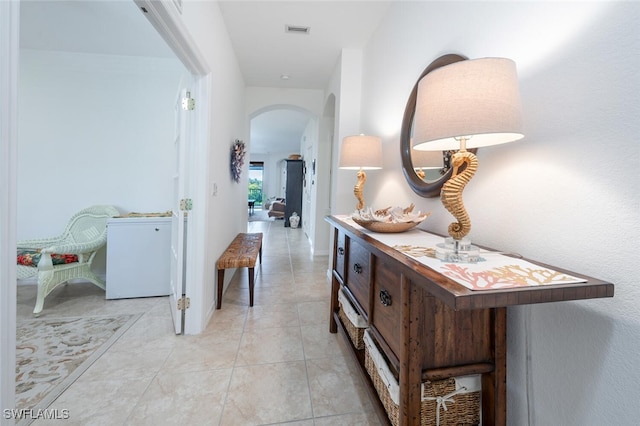 hallway featuring light tile patterned floors