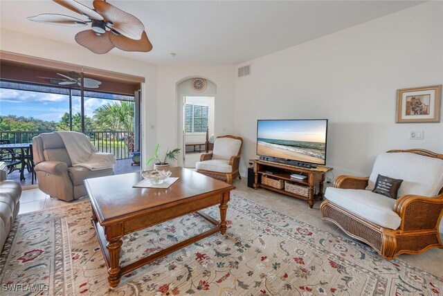 tiled living room with ceiling fan