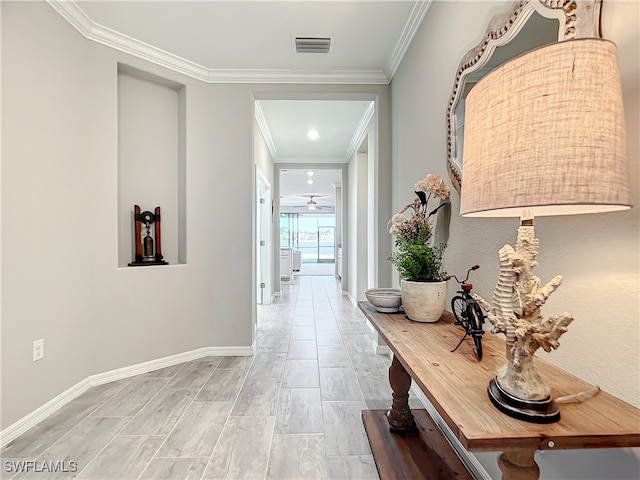 hall featuring light hardwood / wood-style floors and ornamental molding