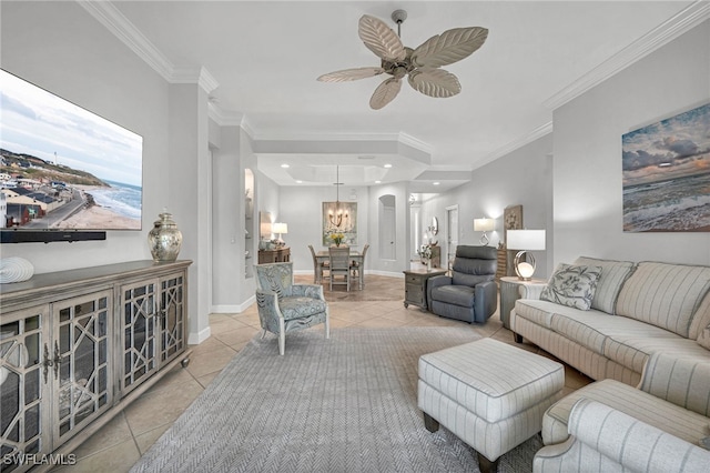 living room with crown molding, ceiling fan with notable chandelier, and light tile patterned floors