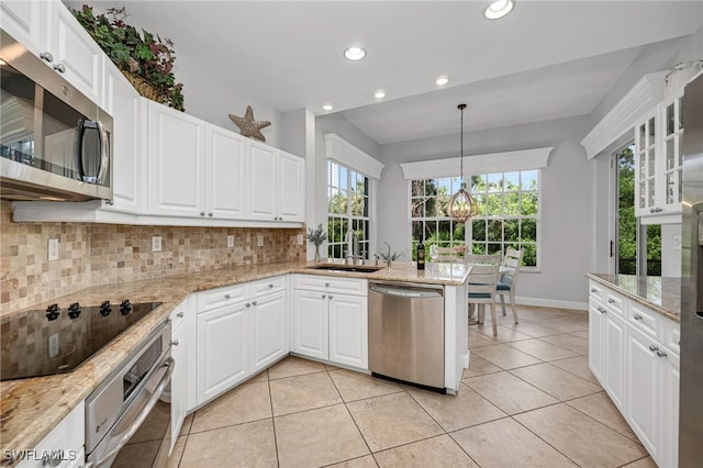 kitchen with appliances with stainless steel finishes, decorative backsplash, and white cabinetry