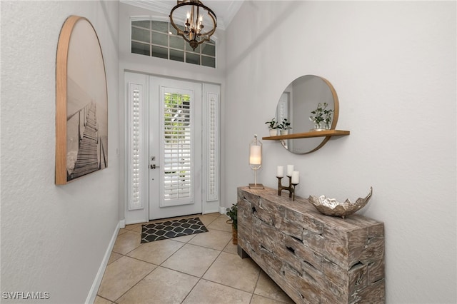 tiled foyer entrance with an inviting chandelier