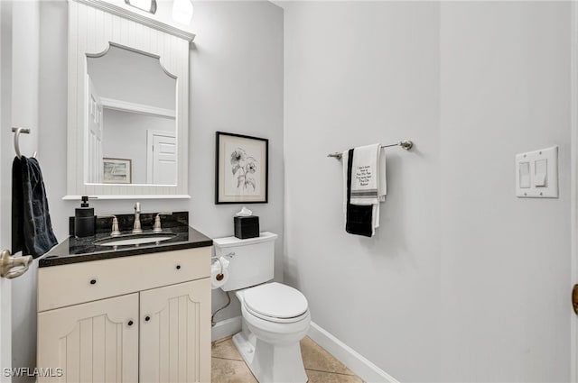 bathroom featuring tile patterned flooring, vanity, and toilet