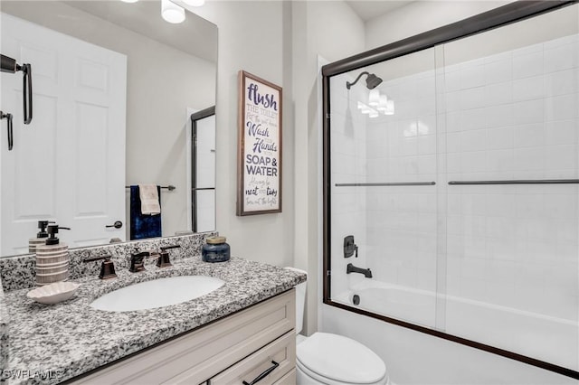 full bathroom with vanity, toilet, and enclosed tub / shower combo