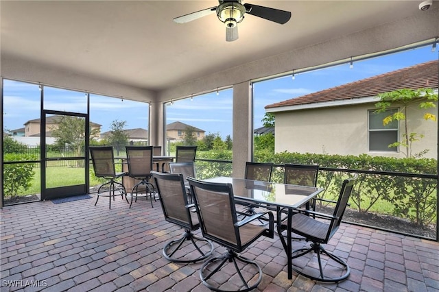 sunroom featuring ceiling fan