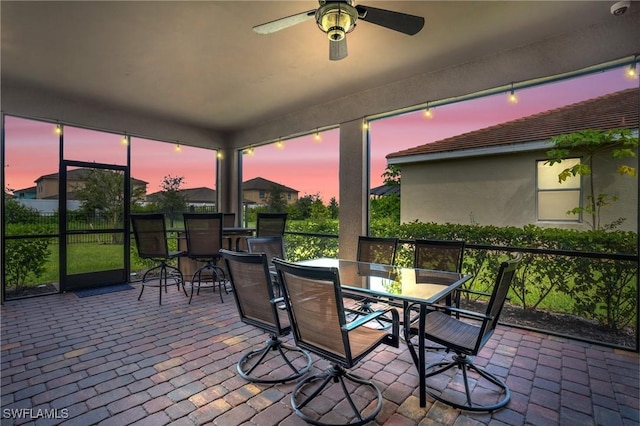 sunroom with ceiling fan