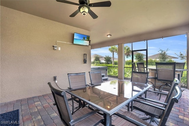 sunroom featuring ceiling fan