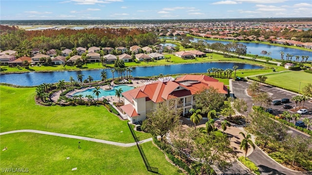 drone / aerial view with a residential view and a water view
