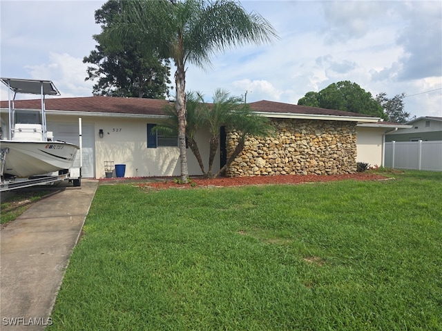 single story home featuring a front yard