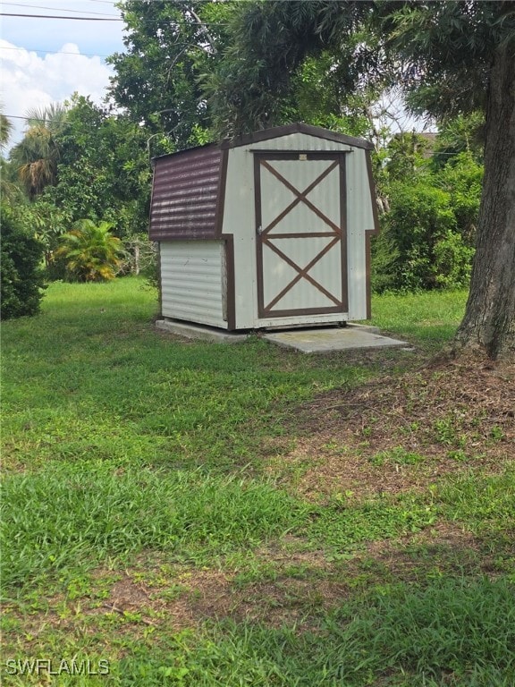 view of outbuilding with a lawn