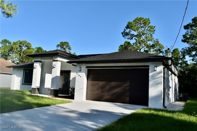 view of front of home featuring central AC unit and a garage