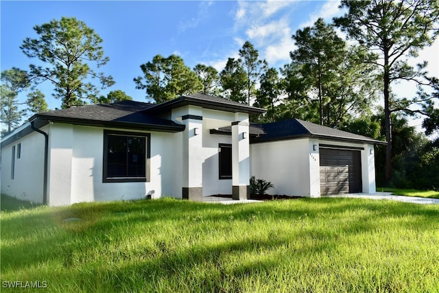 prairie-style home featuring a front yard and a garage