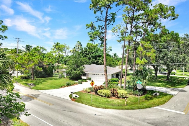 view of front of property with a front lawn and a garage