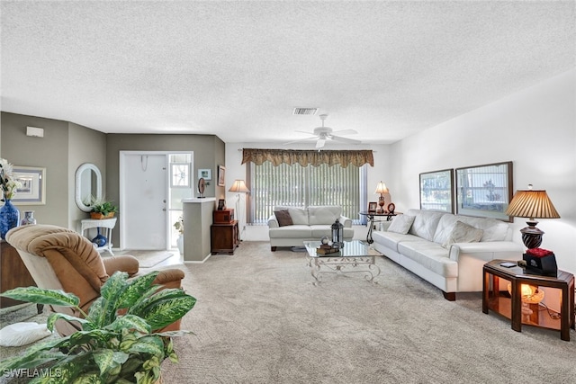 living room with a textured ceiling, light carpet, and ceiling fan