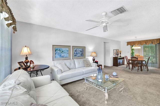 521 Piper Blvd, Naples, FL 34110 - living area with a textured ceiling, carpet, ceiling fan, and a chandelier