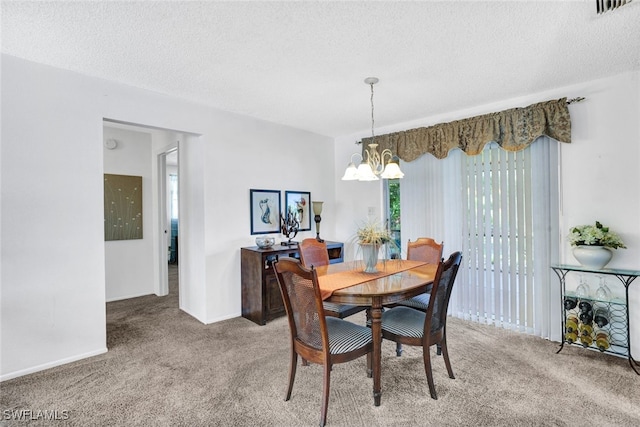 carpeted dining space featuring an inviting chandelier and a textured ceiling