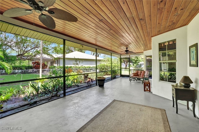 sunroom with wood ceiling and ceiling fan