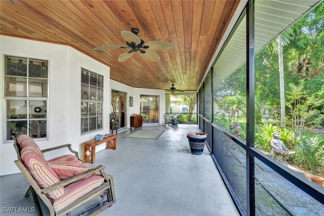 sunroom / solarium featuring wooden ceiling and ceiling fan