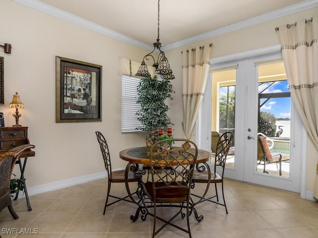 dining room with french doors, light tile patterned floors, and ornamental molding